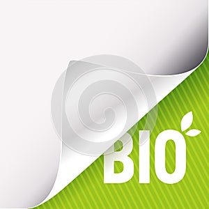 Curled white paper corner on green and Bio sign