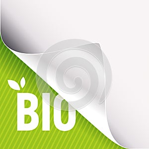 Curled white paper corner on green and Bio sign
