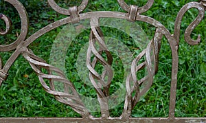 Curlicues on a wrought-iron Park bench. Garden furniture bench