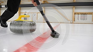 Curling game. Curling granite stone is sliding on an ice sheet.