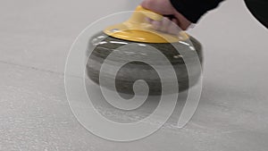 Curling game. Curling granite stone is sliding on an ice sheet.