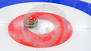 Curling granite stone on ice rink. Winter team olympic sport