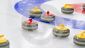 Curling granite stones on ice rink. Winter team olympic sport