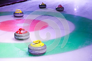Curling stones on ice near the house