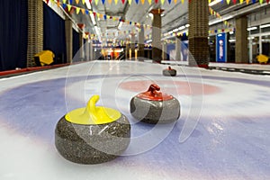 Curling stones on an indoor rink