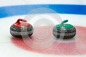 Curling stones in the target on the ice