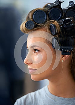 Curls are back in. A beautiful young woman spending the day getting her hair and makeup done.