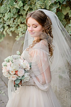 Curls cover shoulders of pretty bride