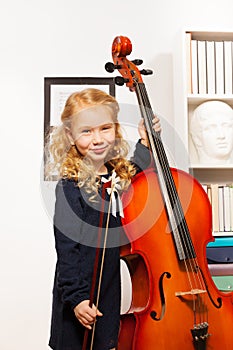 Curly beautiful girl with fiddlestick, violoncello