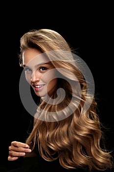 Curly Blonde Hair. Beauty Model With Gorgeous Volume Hair