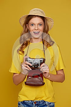 curly blonde woman holding retro vintage photo camera