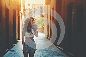 Curly brunette girl talking on phone