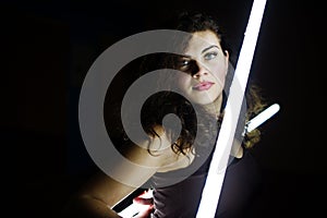 Curly brunette plus size model with two long led lamp photo