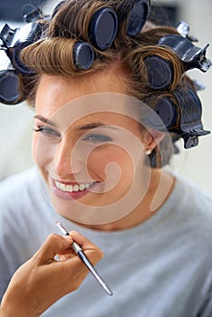 Curly and carefree. A beautiful young woman spending the day getting her hair and makeup done.