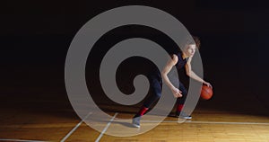 Curly Caucasian Basketball Player Dribbling Ball Camera Professional Darkness Ray Of Light