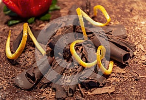 Curly chocolate, garnished with orange peel and strawberry