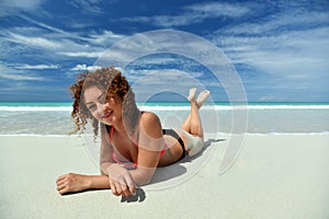 A curly girl on the beach