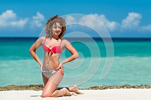A curly girl on the beach tropic