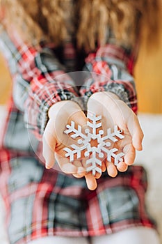 curly girl holding snowflake flaunting hands christmas