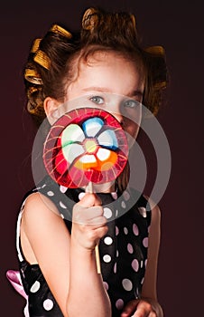 Curly girl with lollipop