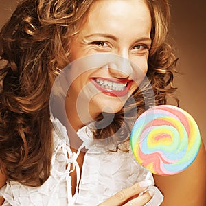 Curly girl with a lollipop in her hand