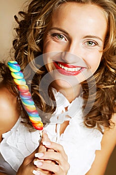 Curly girl with a lollipop in her hand