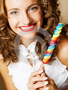 Curly girl with a lollipop in her hand