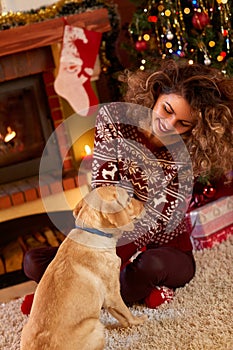 Curly girl with nice dog in Christmas evening