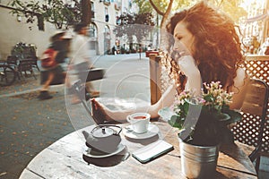 Curly girl in street cafe