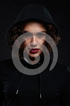 Curly girl wearing black hood