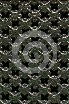 Curly green metal grate background