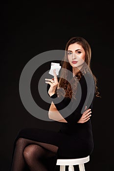 curly hair brunette posing with two aces cards in her hands, poker concept isolation on white background