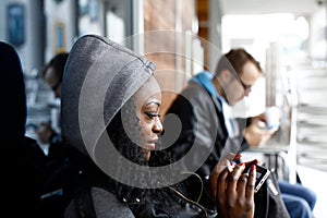 Curly Hair Woman in Gray Hood Using Phone