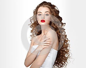 Curly hair woman portrait long hair with perfect make up red lips.