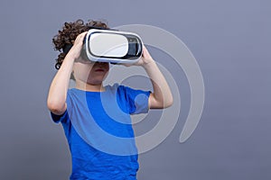 Curly-haired boy with virtual reality goggles