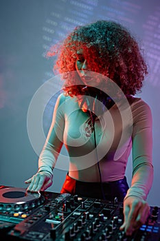 Curly haired girl as DJ