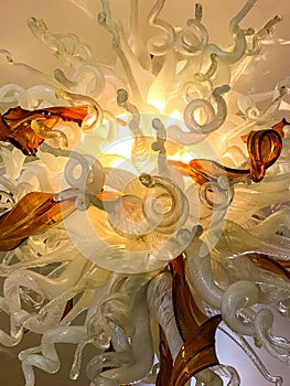 Curly lit glass design in white and amber