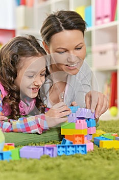 Curly little girl and her mother playing