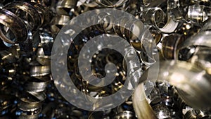 Curly metal chippings after end milling. Macro shot of sharp spirals of silver colored metal. Waste aluminium shavings