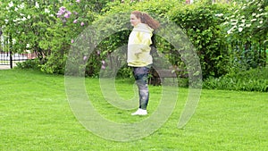 Curly plus size, fat, overweight woman in yellow hoodie do sports exercises, fitness, squat in green park, tree. Dieting