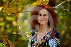 Curly redhead lady in the park