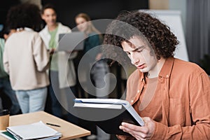 curly student with copybooks thinking near