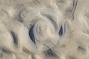Curly, wavy sand pattern on beach