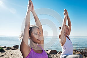 Close up curly appealing woman wearing purple sport shirt doing yoga