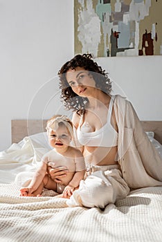 curly woman in loungewear with crop photo