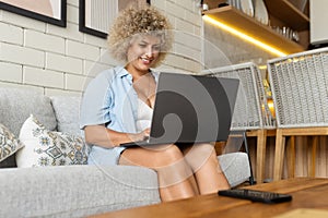 Curly Young Woman Working on Laptop at Home, Casual Lifestyle