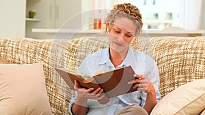 Curlyhaired woman looking at an album