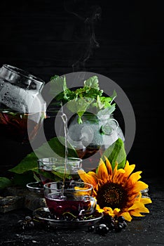 Currant and mint tea. Hot winter drinks. On a black background.