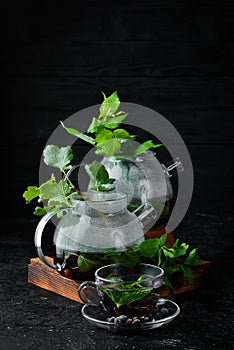 Currant and mint tea. Hot winter drinks. On a black background.