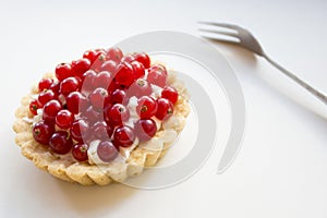 Currant tarts on a plate with raspberries
